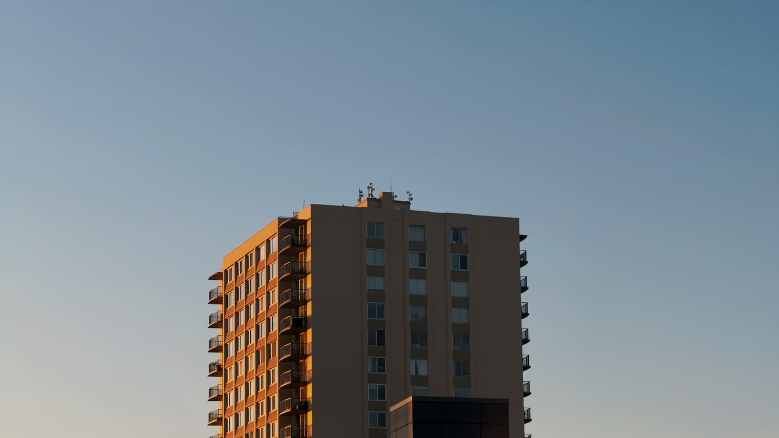 Residential tower glowing in golden-hour light