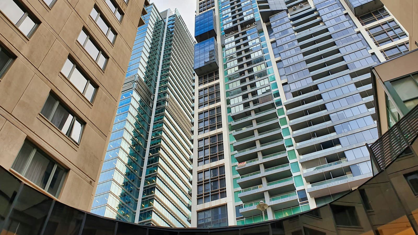 Modern high-rise residential towers seen from street level